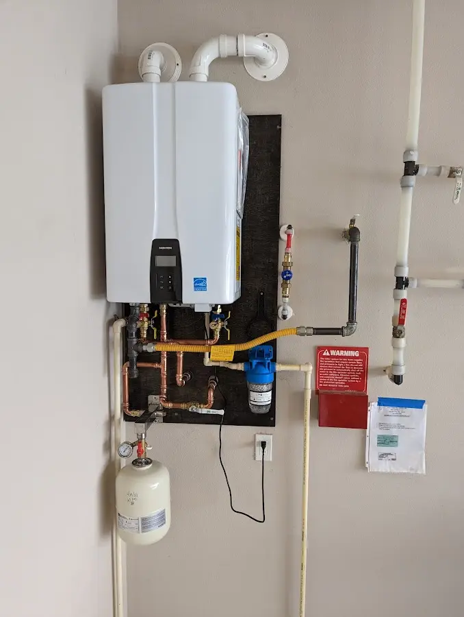 Professional plumber installing copper piping in a Glenburn home